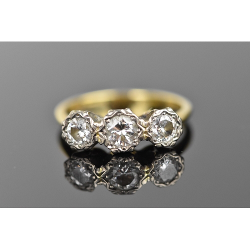 441 - An 18ct yellow and white gold diamond three stone ring, set with three brilliant cut diamonds illusi... 