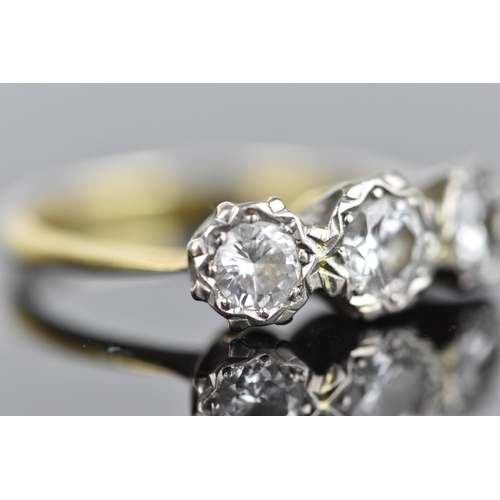 441 - An 18ct yellow and white gold diamond three stone ring, set with three brilliant cut diamonds illusi... 