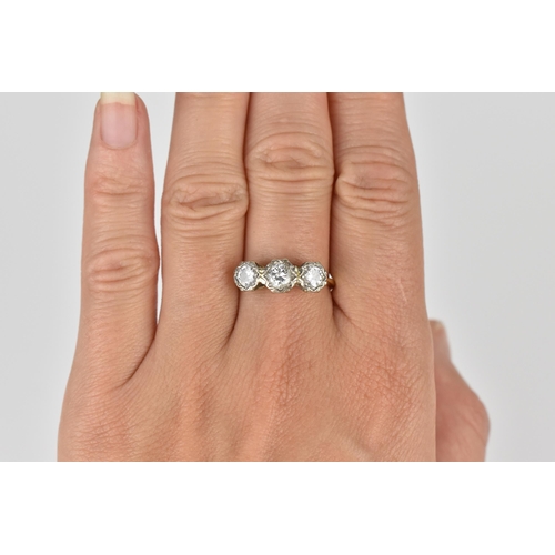 441 - An 18ct yellow and white gold diamond three stone ring, set with three brilliant cut diamonds illusi... 