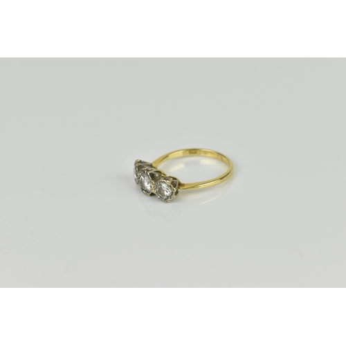 441 - An 18ct yellow and white gold diamond three stone ring, set with three brilliant cut diamonds illusi... 