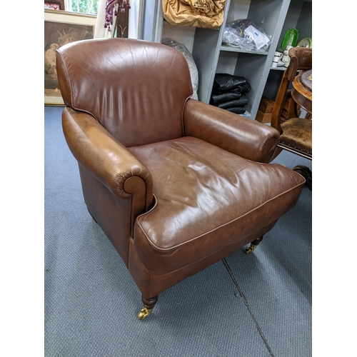 495 - A modern brown leather upholstered armchair Location:LAM