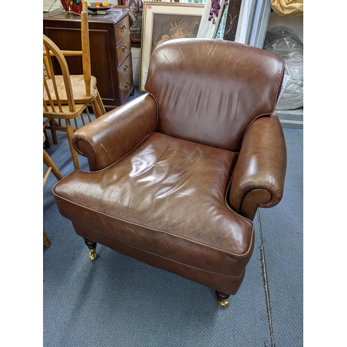 495 - A modern brown leather upholstered armchair Location:LAM