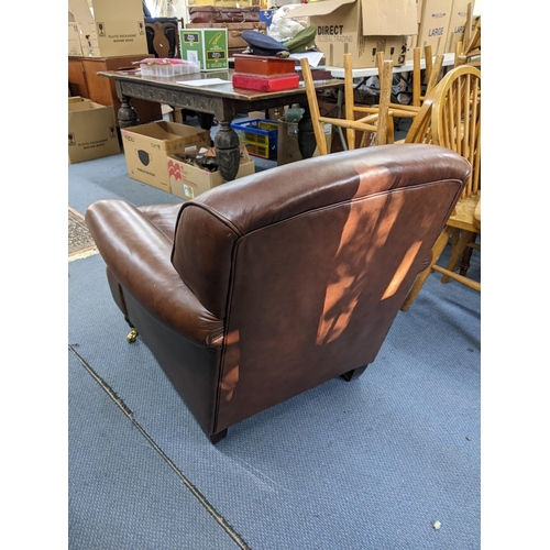 495 - A modern brown leather upholstered armchair Location:LAM