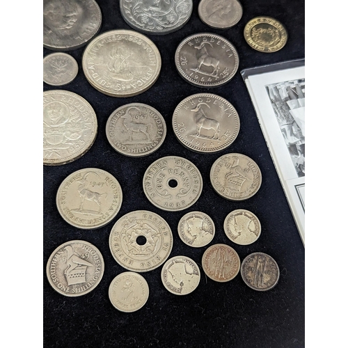 496 - A group of mixed coinage and First Day covers to include a selection of Rhodesian coins, commemorati... 