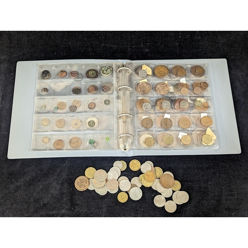 499 - An album containing mixed world coinage, Roman examples, British Colonial and later, commemorative c... 