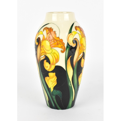 94 - A Moorcroft pottery trial vase in a spring daffodil pattern, with tubelined blooms and leaves on a c... 