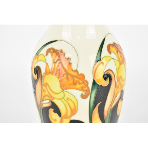 94 - A Moorcroft pottery trial vase in a spring daffodil pattern, with tubelined blooms and leaves on a c... 