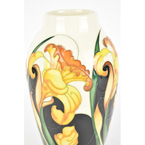 94 - A Moorcroft pottery trial vase in a spring daffodil pattern, with tubelined blooms and leaves on a c... 