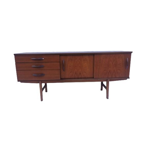 112 - A retro Avalon teak sideboard, designed with by two sliding doors and three left side drawers with m... 