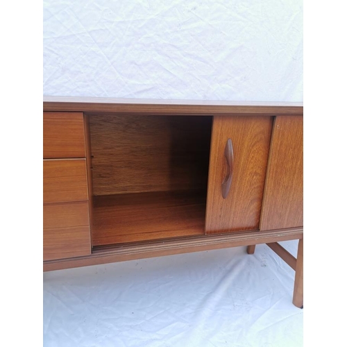 112 - A retro Avalon teak sideboard, designed with by two sliding doors and three left side drawers with m... 