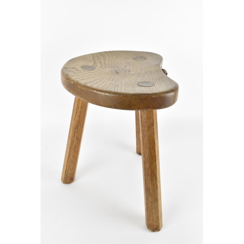 9 - Robert Thompson of Kilburn (1876-1955) Mouseman- a carved oak three-legged stool, with kidney-shape ... 