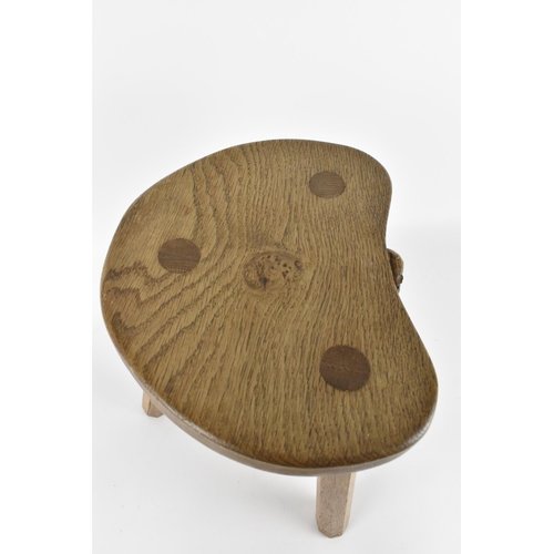 9 - Robert Thompson of Kilburn (1876-1955) Mouseman- a carved oak three-legged stool, with kidney-shape ... 