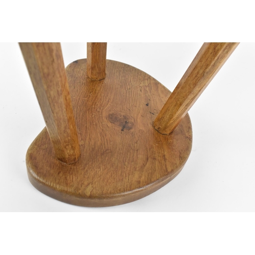 9 - Robert Thompson of Kilburn (1876-1955) Mouseman- a carved oak three-legged stool, with kidney-shape ... 