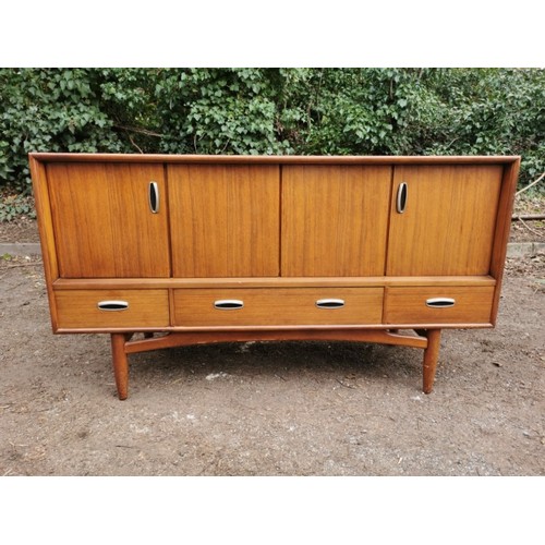 300 - A mid-century G-plan teak 'fresco' sideboard, with two folding doors each enclosing a shelf, over th... 