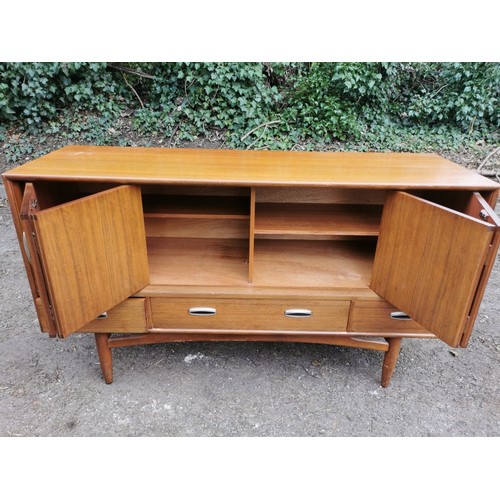 300 - A mid-century G-plan teak 'fresco' sideboard, with two folding doors each enclosing a shelf, over th... 