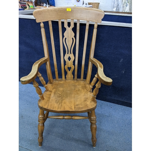 202 - A late 20th century Windsor style lath back beech and elm armchair with carved central splat 
Locati... 