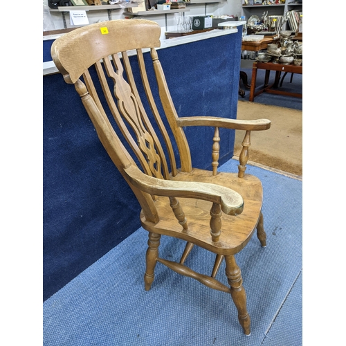 202 - A late 20th century Windsor style lath back beech and elm armchair with carved central splat 
Locati... 