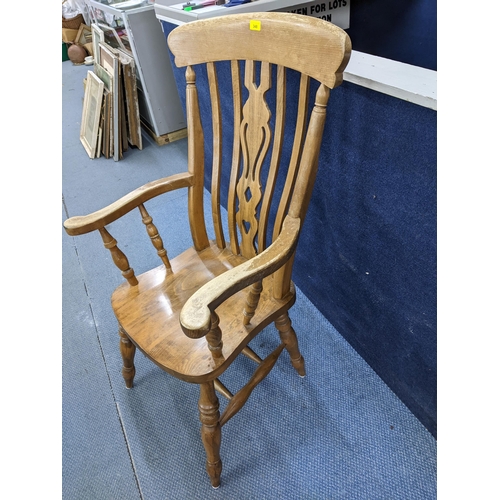 202 - A late 20th century Windsor style lath back beech and elm armchair with carved central splat 
Locati... 