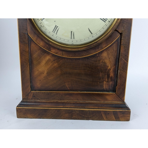 10 - A Regency mahogany bracket clock having an arched top case with boxwood string inlaid, two ring hand... 