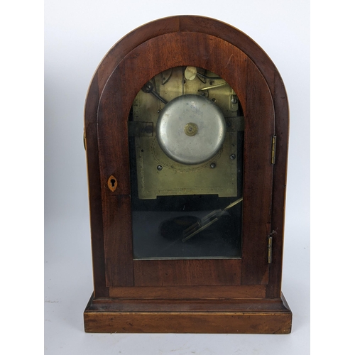 10 - A Regency mahogany bracket clock having an arched top case with boxwood string inlaid, two ring hand... 