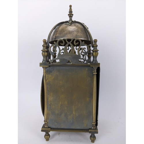 14 - An early 20th century brass lantern clock, in the 18th century style the four post case with 5