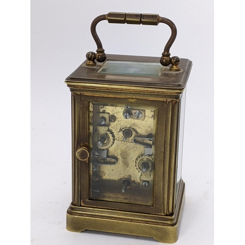 17 - A 19th century French brass miniature carriage alarm clock, the white enamel dial having black Roman... 
