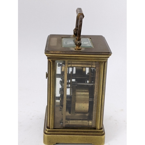 17 - A 19th century French brass miniature carriage alarm clock, the white enamel dial having black Roman... 