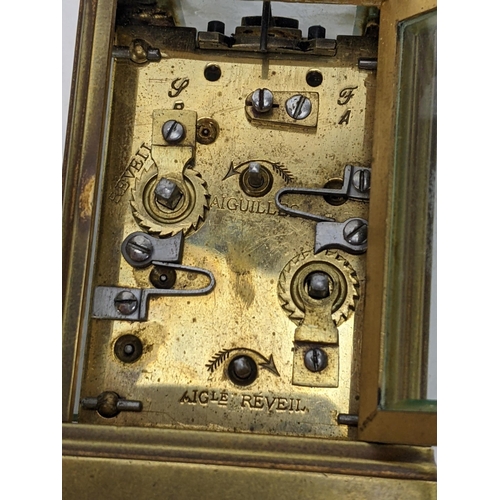 17 - A 19th century French brass miniature carriage alarm clock, the white enamel dial having black Roman... 