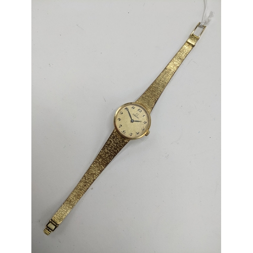 21 - A Omega manual wind ladies 14ct gold wristwatch, circa 1973, having a gilt dial with Arabic numerals... 