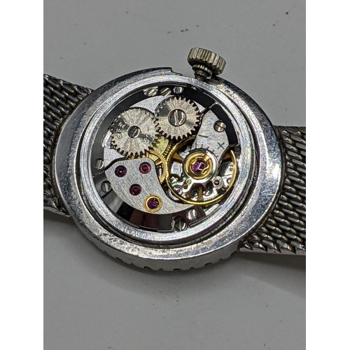 22 - A Ebel manual wind ladies 18ct white gold and diamond wristwatch, having a textured silvered dial wi... 