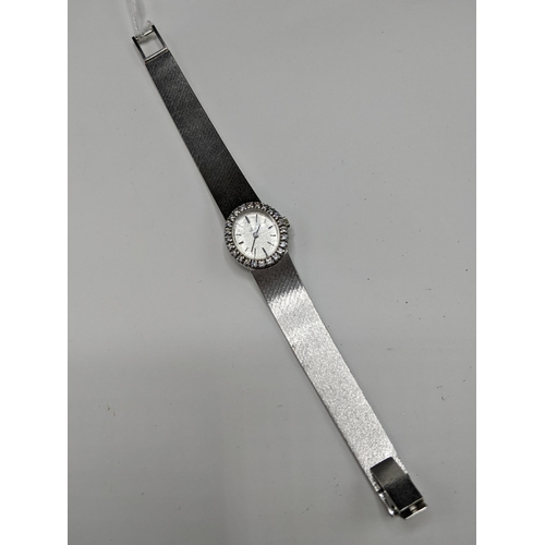 22 - A Ebel manual wind ladies 18ct white gold and diamond wristwatch, having a textured silvered dial wi... 