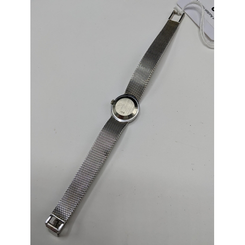 22 - A Ebel manual wind ladies 18ct white gold and diamond wristwatch, having a textured silvered dial wi... 