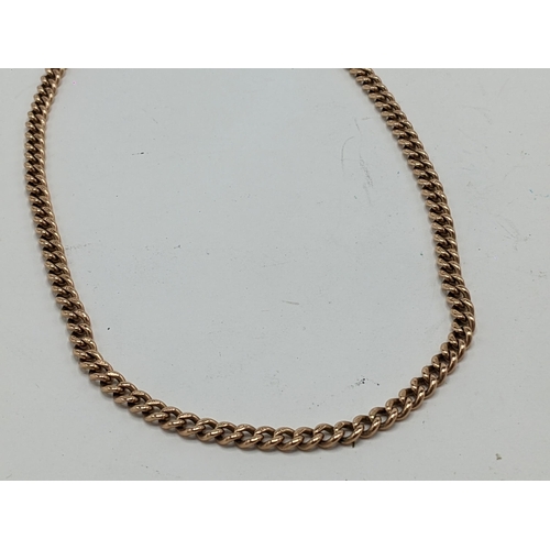 23 - A 9ct rose gold curb link pocket watch chain with a 9ct dog clip and a 15ct dog clip, 43cm long, 29 ... 