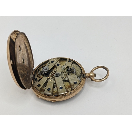 24 - A Victorian 14ct gold, open faced fob watch, having a gilt engraved floral dial, blued hands and Rom... 