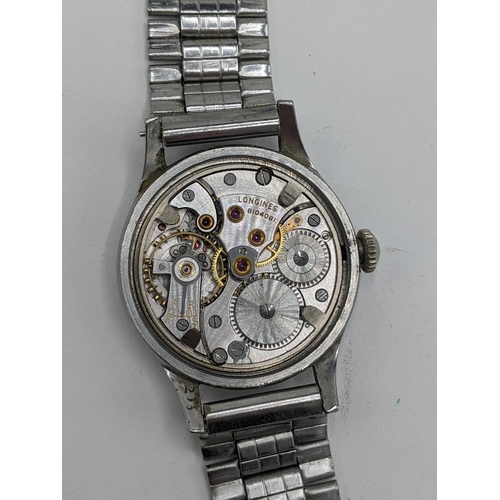 42 - A vintage Longines manual wind, gents, stainless steel wristwatch, having a cream dial signed Longin... 