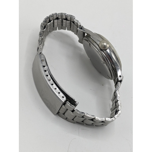 42 - A vintage Longines manual wind, gents, stainless steel wristwatch, having a cream dial signed Longin... 