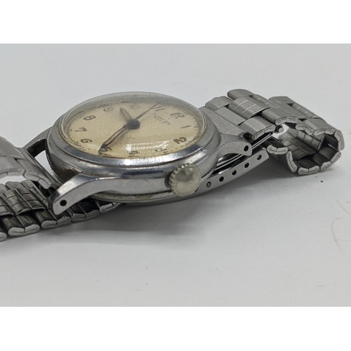 42 - A vintage Longines manual wind, gents, stainless steel wristwatch, having a cream dial signed Longin... 