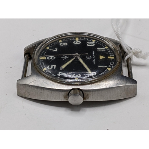 49 - A Hamilton, W10 military issued, gents, stainless steel wristwatch, having a black dial with centre ... 