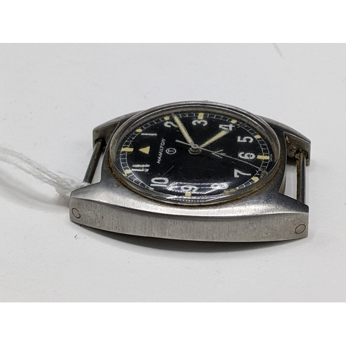 49 - A Hamilton, W10 military issued, gents, stainless steel wristwatch, having a black dial with centre ... 