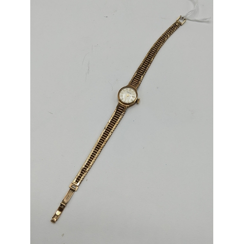 57 - A Nivada manual wind ladies 9ct wristwatch, having a white enamel dial with baton markers, the 17 je... 