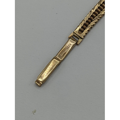 57 - A Nivada manual wind ladies 9ct wristwatch, having a white enamel dial with baton markers, the 17 je... 