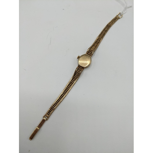 57 - A Nivada manual wind ladies 9ct wristwatch, having a white enamel dial with baton markers, the 17 je... 