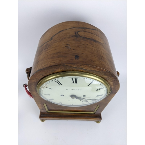 68 - A Regency rosewood bracket clock having an arched top, two ring handles, pierced grilles to both sid... 