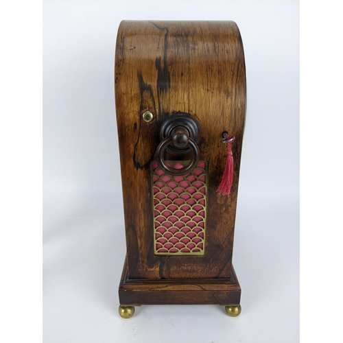 68 - A Regency rosewood bracket clock having an arched top, two ring handles, pierced grilles to both sid... 