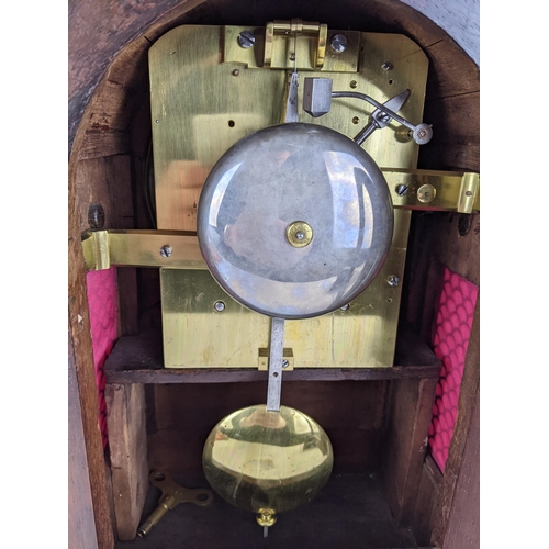 68 - A Regency rosewood bracket clock having an arched top, two ring handles, pierced grilles to both sid... 