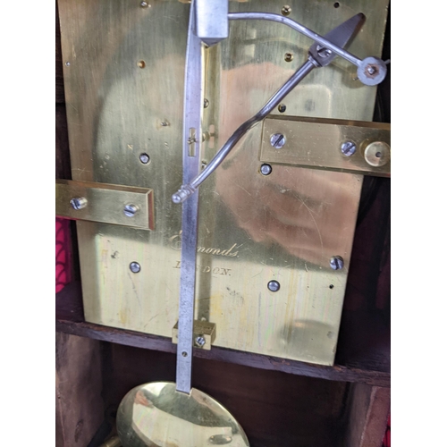 68 - A Regency rosewood bracket clock having an arched top, two ring handles, pierced grilles to both sid... 