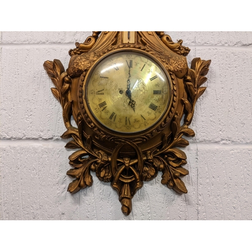 8 - A mid 20th century French Louis XVI style wall hanging clock, the carved gilt wood case having a she... 