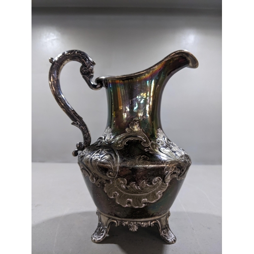 120 - A Victorian silver duck handled jug, shallow raised floral repousse decoration in the rococo style, ... 