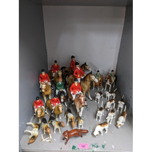 163 - Beswick, Bretby and other model hunting hounds and riders comprising two Beswick riders on ponies, 8... 