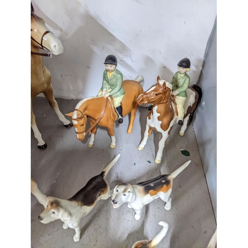 163 - Beswick, Bretby and other model hunting hounds and riders comprising two Beswick riders on ponies, 8... 